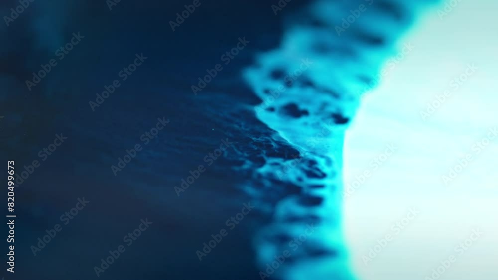 Poster close-up of blue ink diffusing in water, creating an abstract, swirling effect