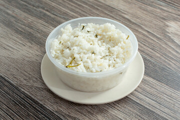 A view of a plastic container of cilantro rice.