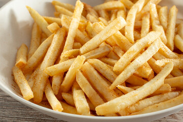 A closeup view of a bowl of French fries.
