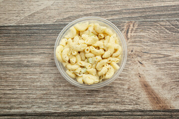 A top down view of a container of macaroni salad.