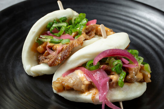 A closeup view of pork belly chasu buns.