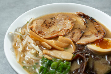 A closeup view of a shoyu ramen, with chasu pork slices.