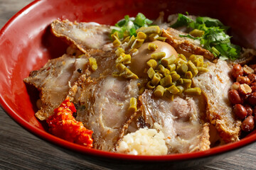 A closeup view of a bowl of crispy pork rice noodle.