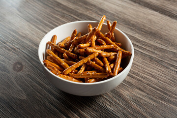 A view of a bowl of gluten-free pretzel sticks.