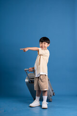 Portrait of asian boy posing on blue background