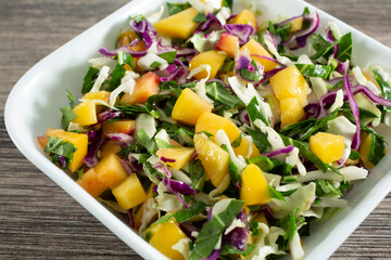 A closeup view of a bowl of mango cabbage slaw.