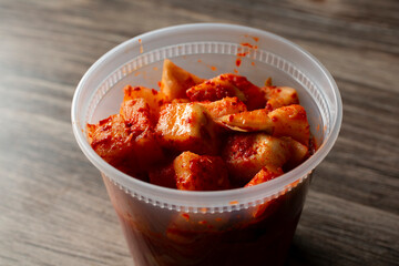 A view of a container of daikon radish kimchi.