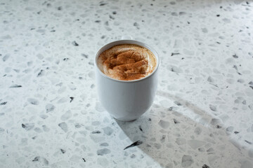 A view of a hot cinnamon latte drink.
