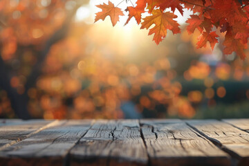 A wooden desk top with blurred background of maple tree with autumn foliage. Good for background 