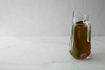 A view of a glass pitcher of kombu water, on the right side of the frame.