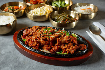 A view of pork bulgogi and various banchan dishes.