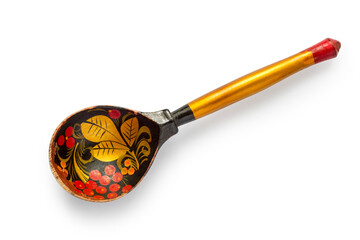 Russian wooden spoon with patterns on a white background. Close-up of an old wooden spoon.