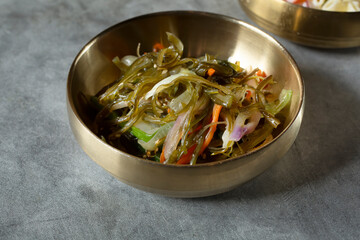 A closeup view of a japchae banchan bowl.