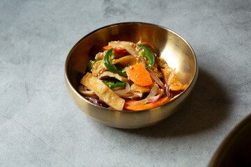 A view of a small bowl of stir-fried fish cake banchan.