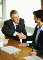 Business people, handshake or collaboration in office together for meeting, contract discussion or deal negotiation. Corporate, men or employees in workplace for b2b plan, teamwork and feedback