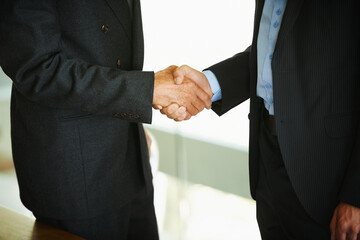 Business people, handshake or collaboration in office together for meeting, contract discussion or deal negotiation. Corporate, partner or employees in workplace for b2b plan, teamwork and feedback