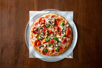 A top down view of a deluxe personal pizza.