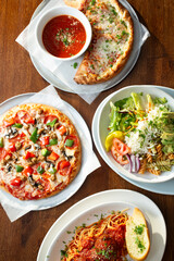 A top down view of a variety of Italian entrees.