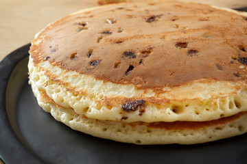 A closeup view of big chocolate chip pancakes.