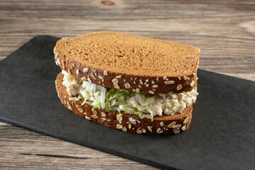 A view of a tuna salad sandwich on squaw-bread.