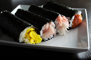 A closeup view of a variety of hand rolls.