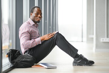 black student at university classroom and thinking of something