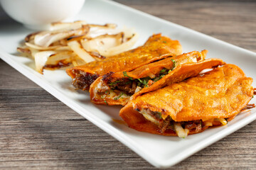 A view of a plate of quesabirria tacos.