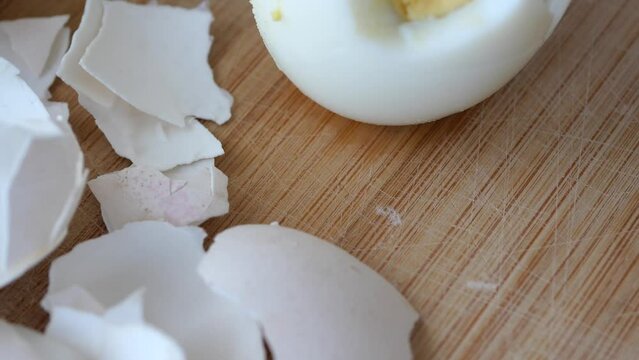 Broken egg shell on wooden cutting board, 
