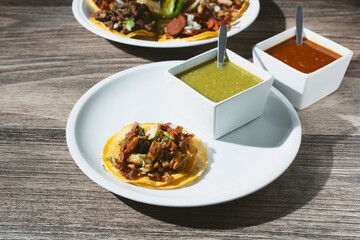 A view of a tripa street taco, with some salsas.