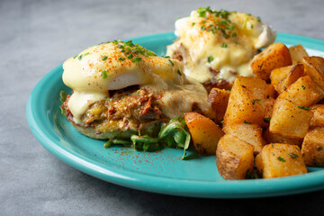A closeup view of a plate of short ribs eggs Benedict.