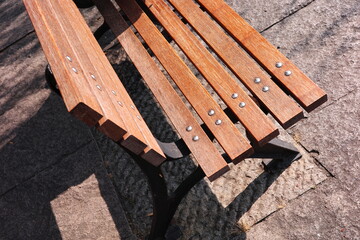 Close-up of a leisure wooden bench in a city park