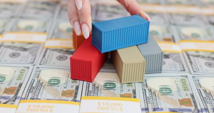 Shipping containers on stacks of 100 bills