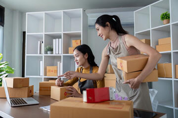 Asian women organizing ecommerce logistics for online business. Concept of teamwork, efficient...