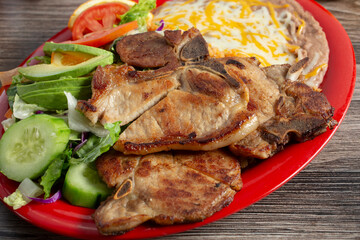 A view of a plate of chuletas de puerco.
