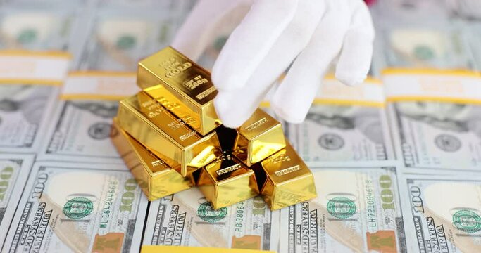 Stack of gold bars on monetary dollar bills