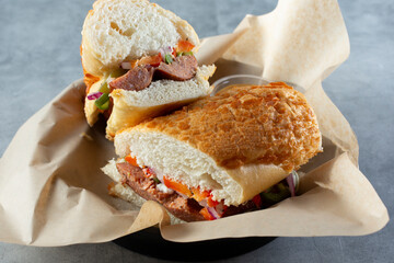 A view of a spicy Andouille sausage sandwich.