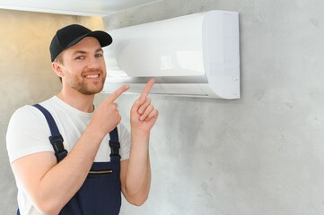 Service man is cleaning, repair and maintenance of air conditioner.