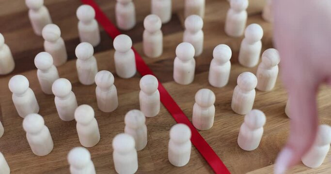 Wooden figures separated red line