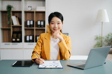 Businesswoman Analyzing Finance on Tablet and Laptop at modern Office Desk tax, report, accounting,...