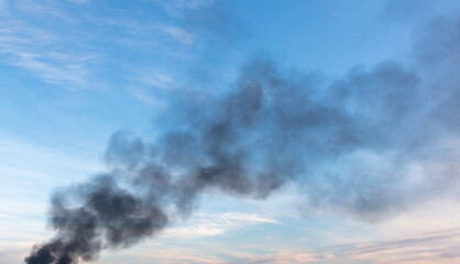 Black smoke from a fire against the sky