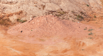 A pile of sand lies on the ground