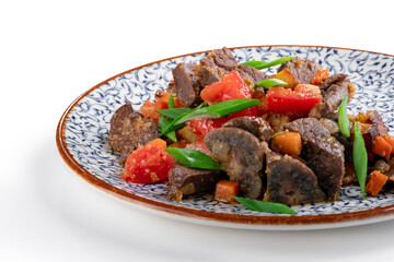 Fragrant roast of offal, lamb or beef meat with tomatoes and onions in a plate, isolated on white. A Central Asian dish made from the heart or lung of mutton, close up