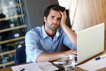 Burnout, laptop and portrait of business man at desk in office with pressure of project deadline. Bankruptcy, debt or finance and accountant with depression working on computer for audit or tax