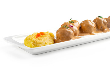 Meat meatballs with mustard sauce and sesame seeds in a white plate isolated on a white background, close up