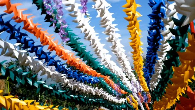 Footage of a gorgeous amusement park with colorful origami pinwheels against a bright blue sky, Pinwheel garden and amusement park in Bandung, Asia. 4K Video Resolution 