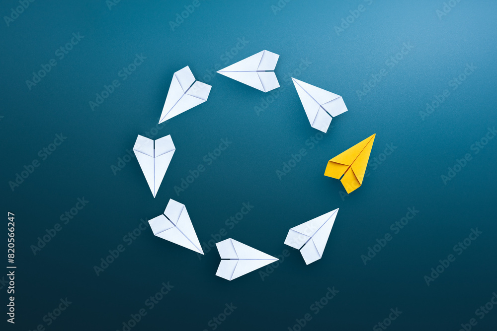 Wall mural group of white paper planes float in a circular direction and one yellow paper plane pointing in dif - Wall murals