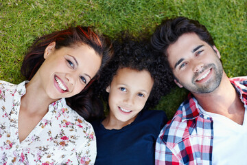 Top view, sunshine and family on grass, portrait and happiness with smile, bonding together and...