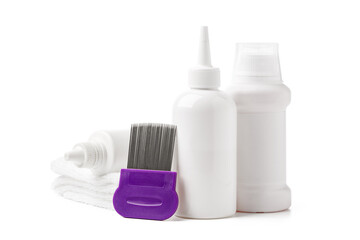 Comb, anti lice medicine and towel on white background
