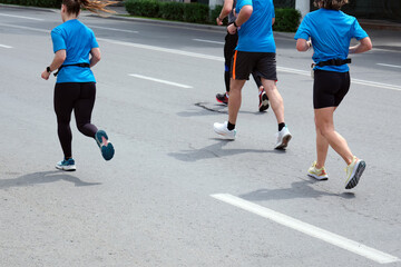 Urban marathon runners on the street in the city.