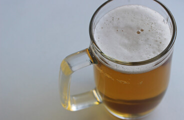 Rich color of indian pale ale in a classic beer glass on white surface top view. Foam On Pale Ale In A Beer Mug Extreme Closeup Stock Photo. 